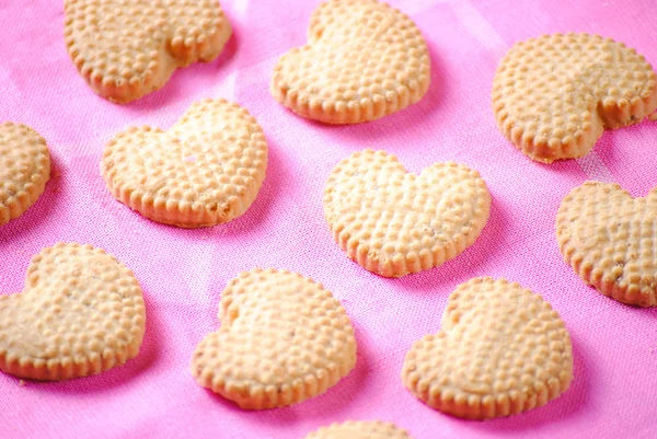 Heart shaped cookies on pink cloth — Stock Photo, Image