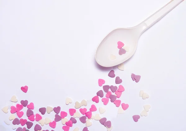 Heart candies on white spoon — Stock Photo, Image