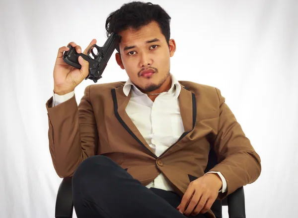 Businessman bodyguard on brown suit holding the gun — Stock Photo, Image