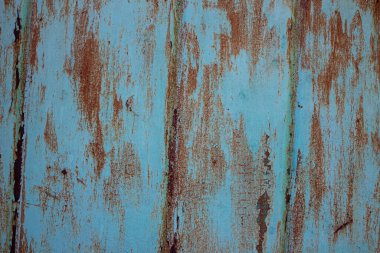 Kabuğu soyulmuş ve çatlamış mavi boyalı paslı metal yüzey dokusu. Arkaplan