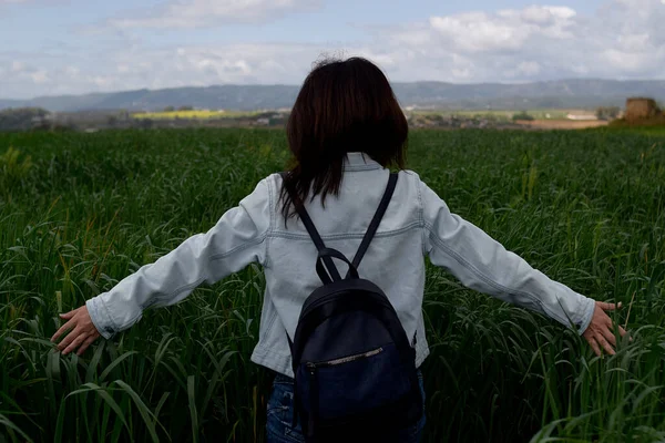 Model walking through wheat plantation, with intense green color