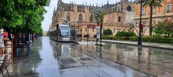 Sevilla Espaa 2021 Tram Seville Seville Cathedral Background Rainy Dayhorizontal — Stock Photo, Image