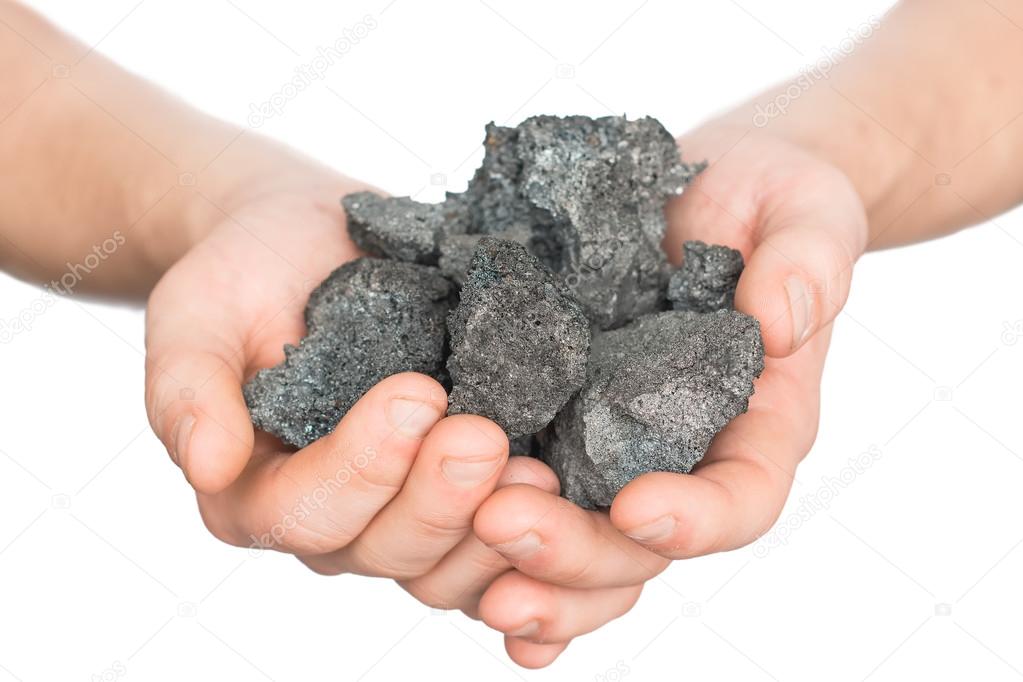 coal coke in hand on white background