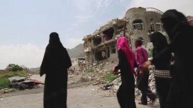 Taiz / Yemen - 04 Sep 2016 : People passed by the buildings that were destroyed during the war between the Popular Resistance and Al-Houthi militia in Taiz City