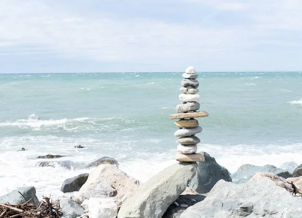 Stacks of balanced round stones on beach. Zen concept.