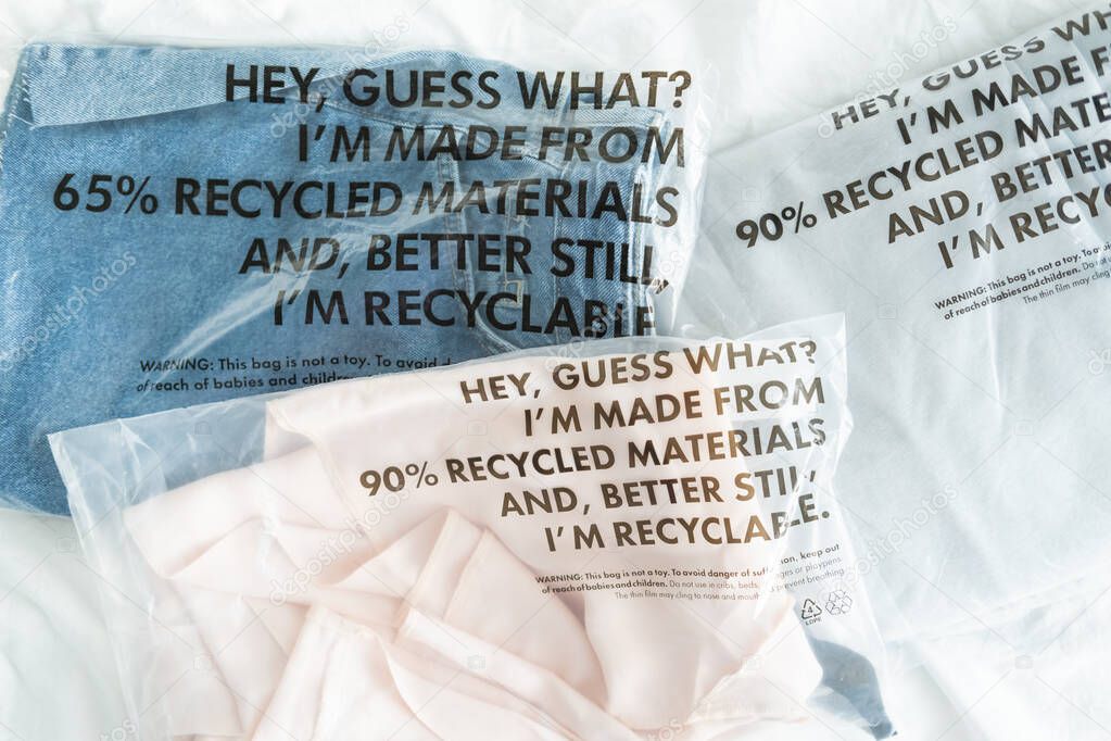 Clothes in plastic bag with tag recycled materials and recyclable. zero waste concept