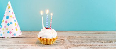 Mavi arka planda mumları olan kutlama keki. Doğum günü ya da tatil için dekorasyon. Bayram afişi, alanı kopyala.