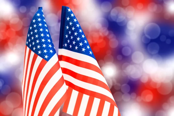 American flag on a background of colored bokeh of white, blue and red colors. For the Independence Day of the United States.