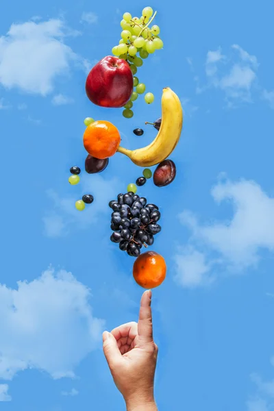 Fresh fruit balancing on a human hand. — Stock Photo, Image