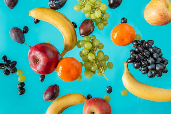Fresh fruits on a blue background. — Stock Photo, Image