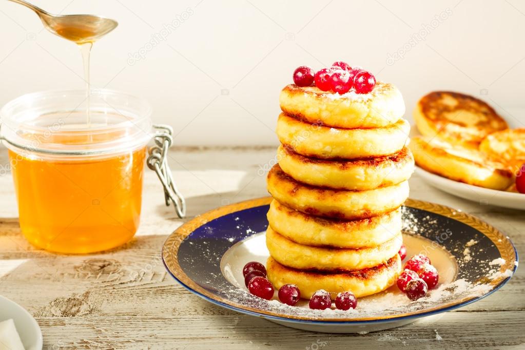 Delicious cottage cheese pancakes with honey and cranberries.