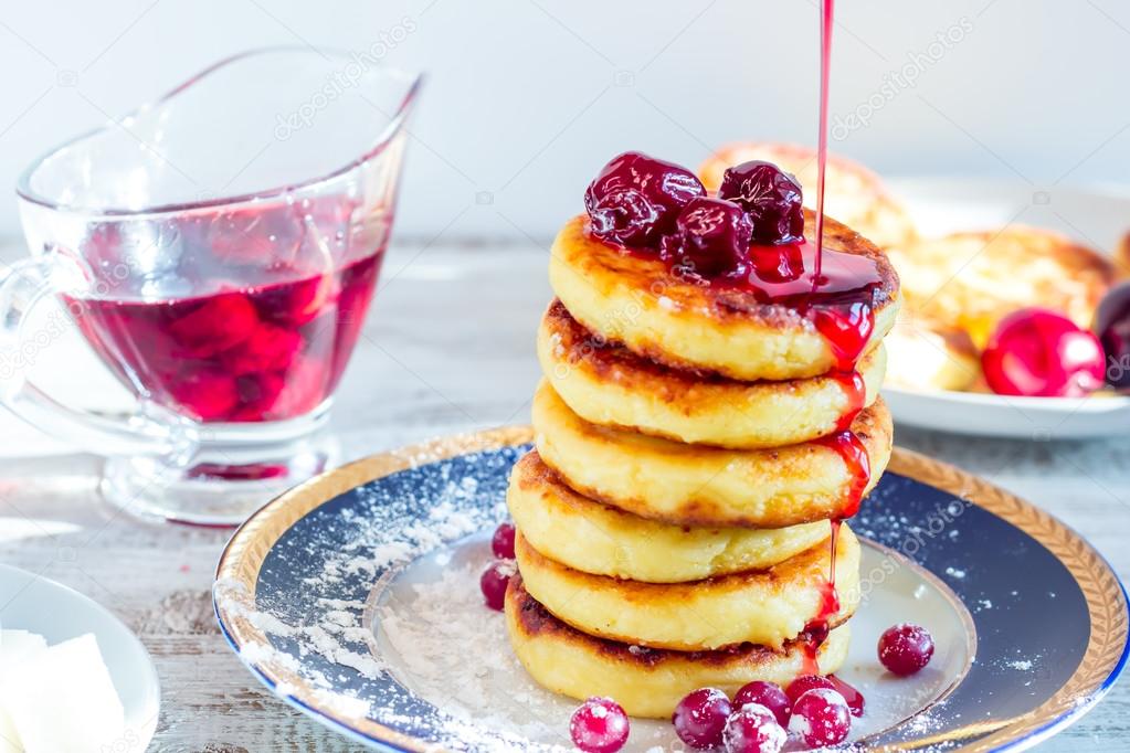 Delicious cottage cheese pancakes with cherry jam and cranberrie