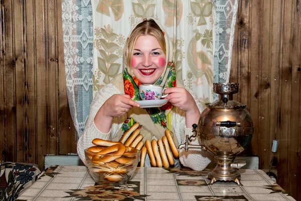 Woman in traditional scarf drinking tea. — Stock Photo, Image