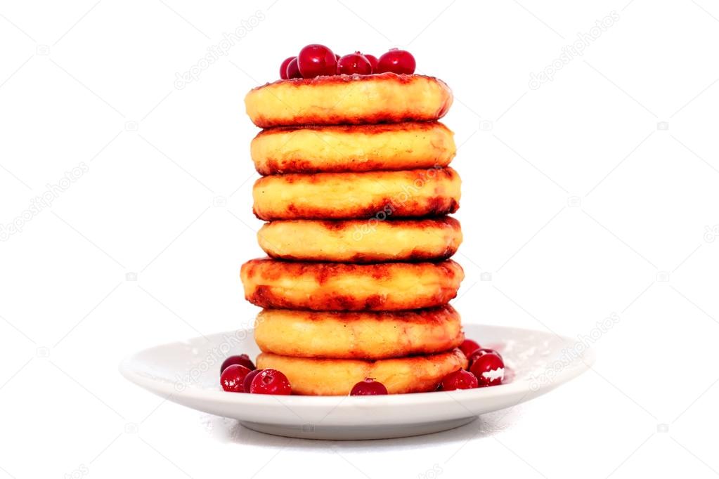 Cottage cheese pancakes with cranberries on a  plate.