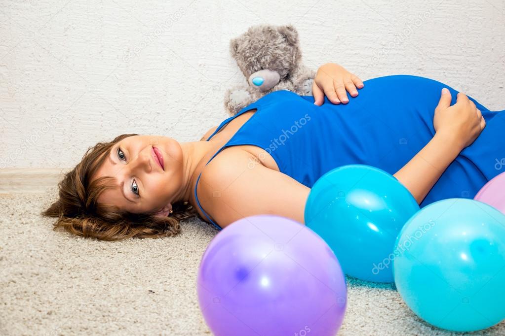 Pregnant woman lying on the floor.