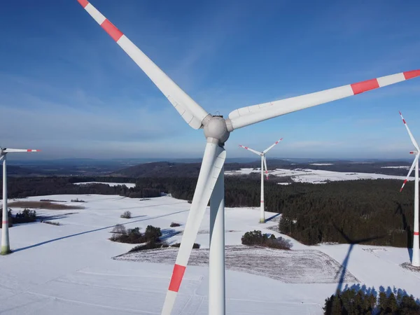 Aerial view of a wind farm in winter. Aerial view of wind turbines on a snowy field in Germany.