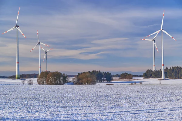 Brede Opname Van Een Windmolenpark Een Besneeuwd Veld Bij Zonsondergang — Stockfoto