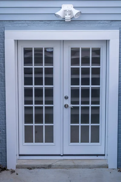 Double walkout door with white frame and grills