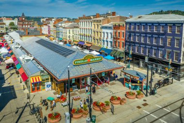 Aerial view of colorful Findlay market in the re-gentrified Over the Rhine neighborhood of Cincinnati Ohio USA with street vendors clipart
