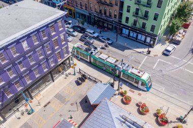 Aerial view of the green tram, light rail, city connector in inner city Cincinnati, vital public transportation clipart