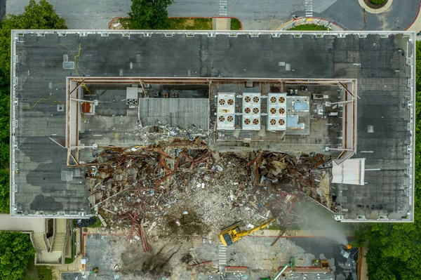 Aerial view of an office building under demolition by a wrecking ball in Columbia Town Center  Maryland new Washington DC