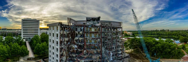Aerial view of an office building under demolition by a wrecking ball in Columbia Town Center  Maryland new Washington DC