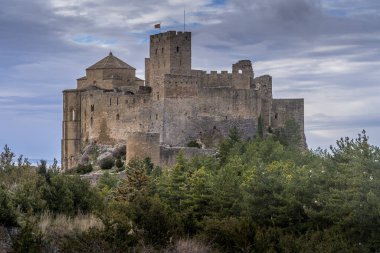 İspanya 'nın Aragon bölgesindeki Huesca yakınlarında, yüksek bir kayanın tepesinde yuvarlak kuleleri, donjon ile kısmen restore edilmiş Romen Loarre kalesinin kış manzarası