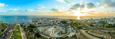 Aerial summer sunset view of Acco, Acre, Akko medieval old city with green roof Al Jazzar mosque and crusader palace in Israel clipart