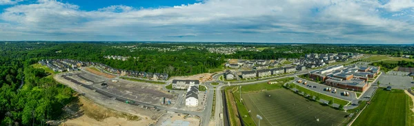 Aerial view of new middle class residential community multi-family development project with apartments, condos, duplexes, town homes and single family homes neighborhood