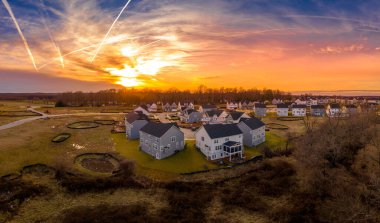 Gorgeous colorful sunset over a new residential neighborhood with single family homes in Maryland East Coast USA clipart