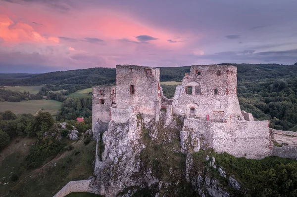 Aerial view of ruined Gothic Csesznek castle in the Bakony region of Hungary in Veszprem county with old palace building, gate tower with colorful dramatic sunset