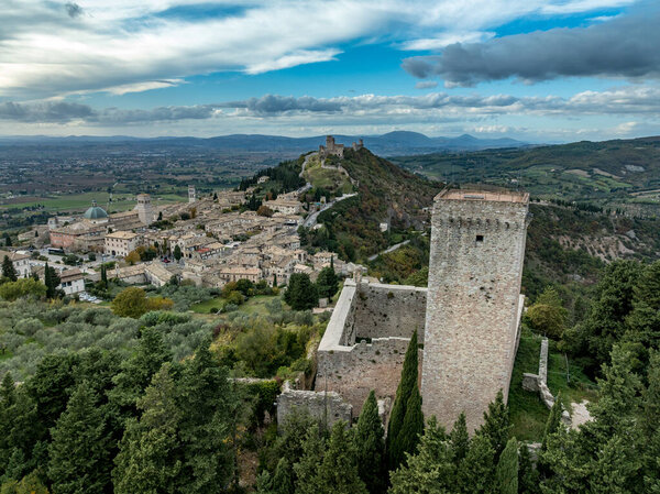 An aerial view of Assisi Rocca Minore medieval castle protecting the town from the hills with square tower in Umbria Italy