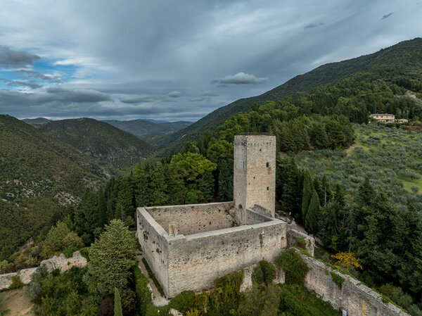 An aerial view of Assisi Rocca Minore medieval castle protecting the town from the hills with square tower in Umbria Italy