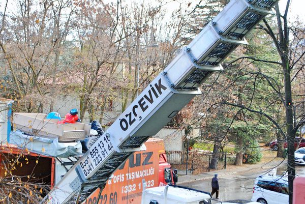 Ankara Turkey. Dec. 2020. Moving lift carrying furniture up at a residential area.