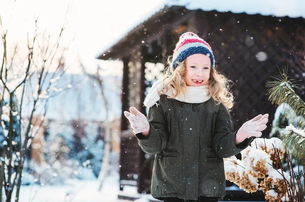 Happy child girl playing with snow on snowy winter walk — Stock Photo, Image