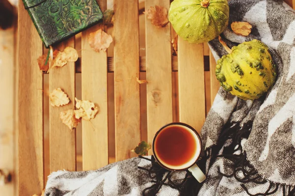Nyaman musim gugur pagi di rumah desa, secangkir teh dan selimut hangat di atas meja kayu. Masih hidup rincian — Stok Foto