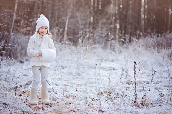Cute happy child girl walking in snowy winter forest — Stock Photo, Image