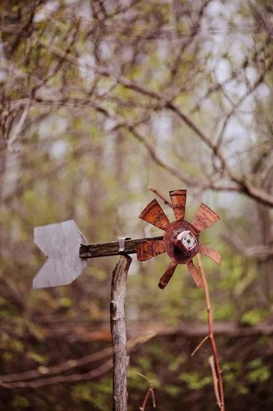 Rustic handmade windmill in early spring garden — Stock Photo, Image