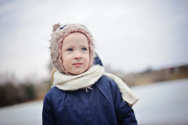 Cute toddler girl outdoor portrait in owl hat and blue coat — Stock Photo, Image