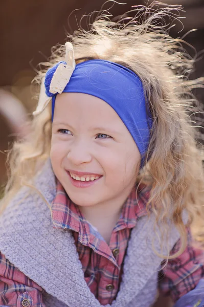 Spring portrait of happy child girl in blue headband — Stock Photo, Image