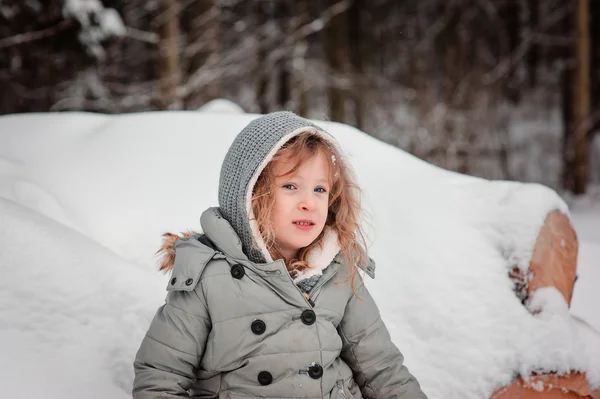 Winter portrait of child girl on the walk in snowy forest — Stock Photo, Image