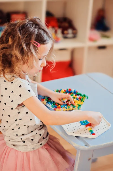 Preschooler child girl play with mosaic at home — Stock Photo, Image