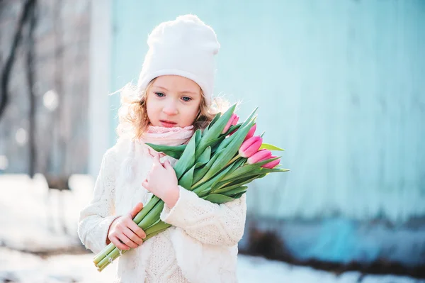 Retrato de primavera de niña adorable con tulipanes ramo en el paseo — Foto de Stock