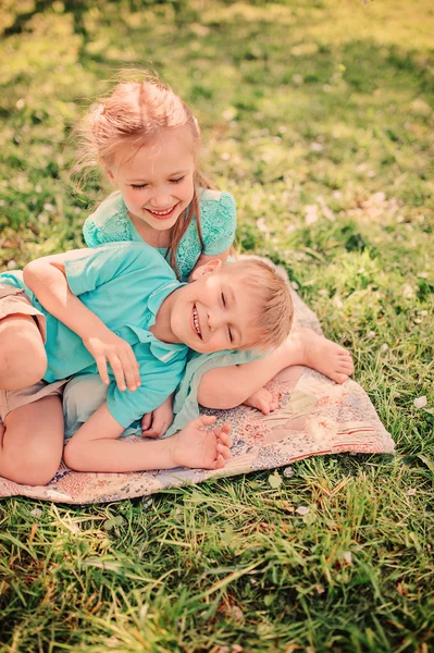 Glückliches Geschwisterpaar im blühenden Garten — Stockfoto