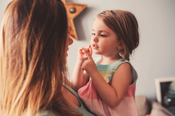 Mutlu sevgi dolu bir anne ve bebek kızı eğleniyor ve evde oynamak — Stok fotoğraf