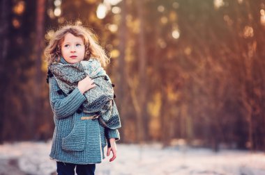 child girl on cozy warm outdoor winter walk
