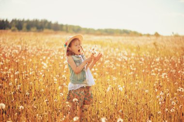 happy child on summer field, spending vacation outdoor, warm rural scene