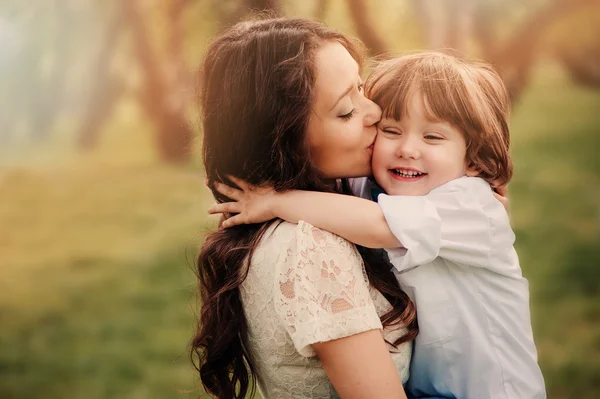 happy mother and toddler child on cozy outdoor summer walk