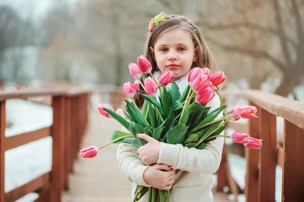Child girl with bouquet of tulips — Stock Photo, Image