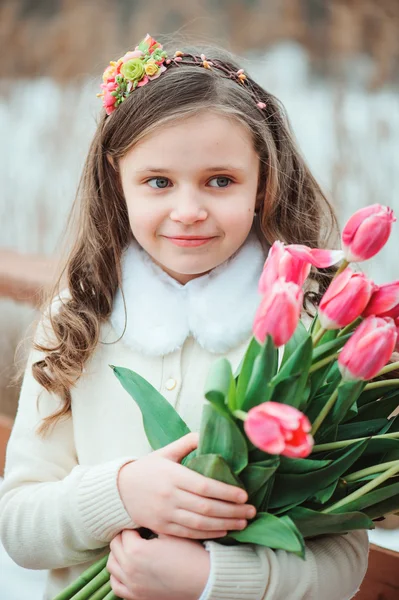 Child girl with bouquet of tulips — Stock Photo, Image